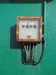 SX03024 Rusty box of switches on green wall.jpg